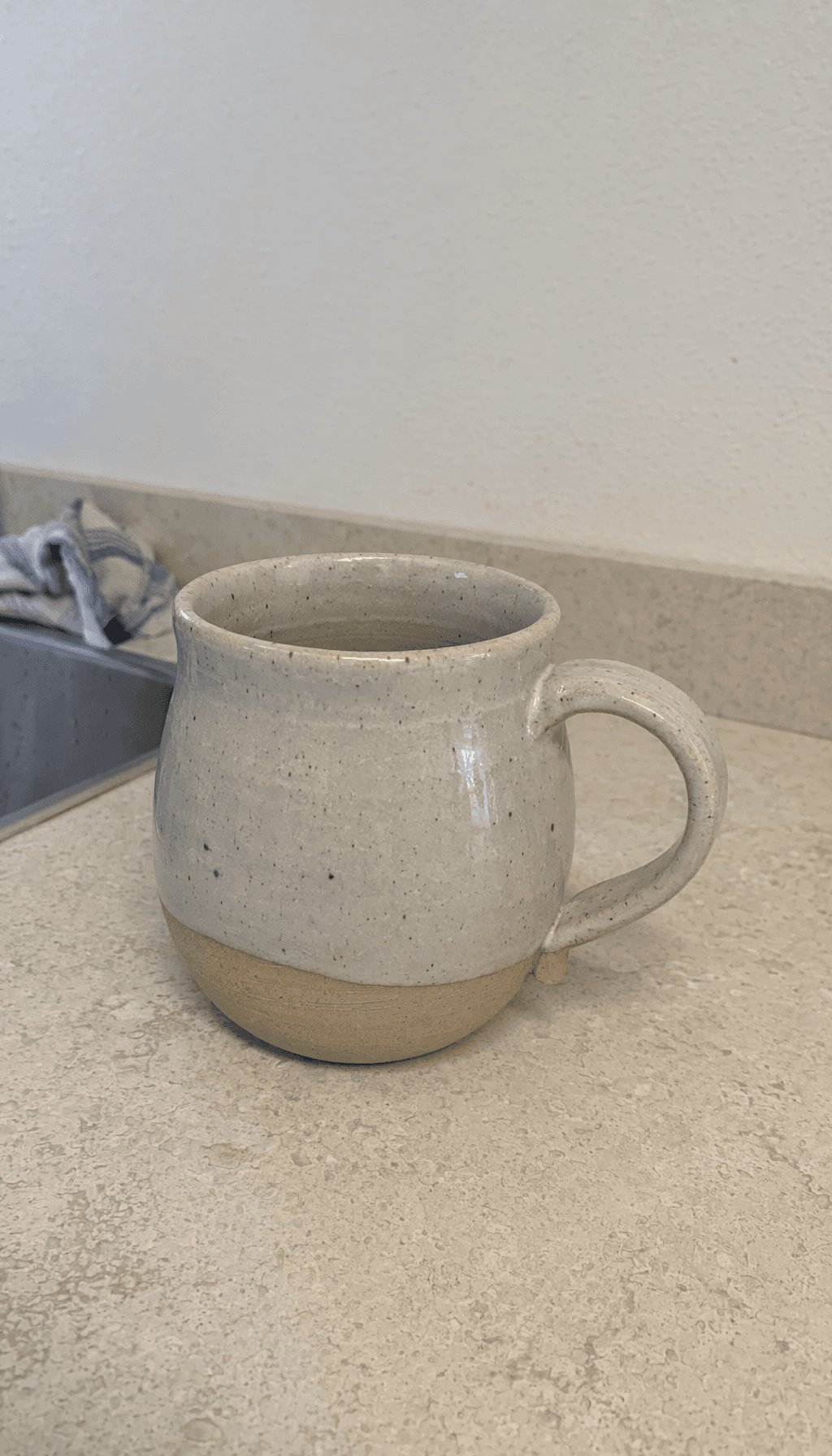 Ceramic mug photographed on a kitchen counter before cleanup